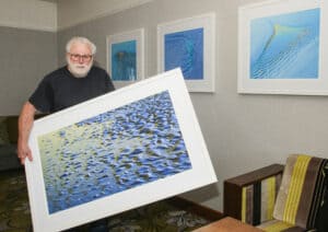 Photographer John Ironside hanging his new installation of photographs in Ferrycarrig Hotel.